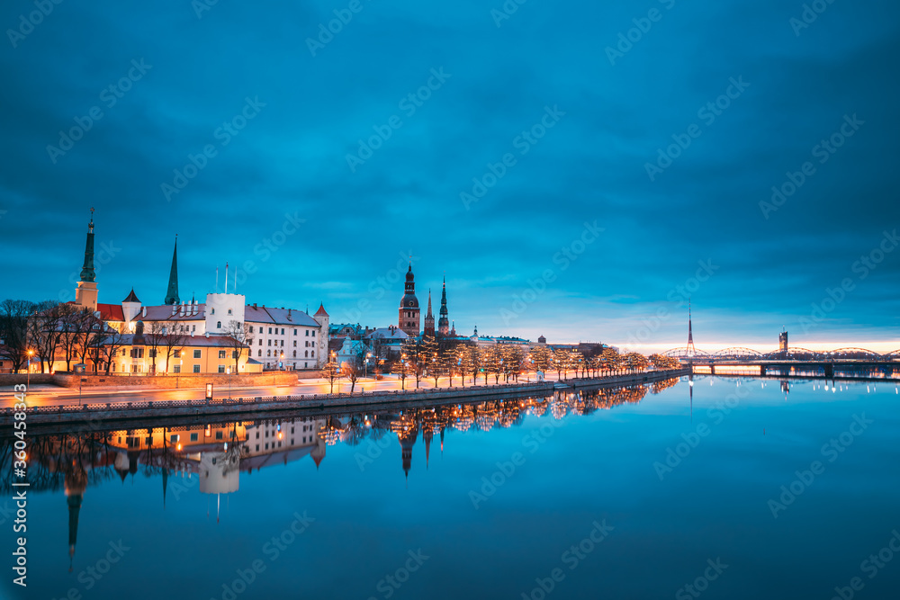 Riga, Latvia, Europe. Cityscape In Morning Time. Night View Of Castle, Dome Cathedral And St. Peter's Church. Popular Place With Famous Landmarks. UNESCO. Old Town In Street Christmas Decoration