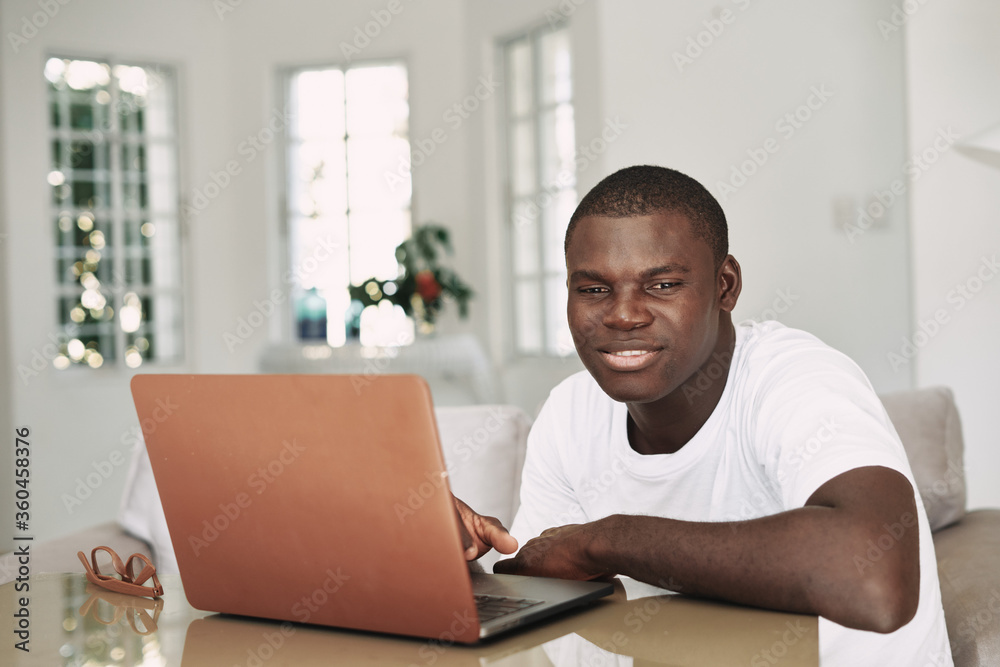 Male african american freelancer with laptop Male african american freelancer with laptop