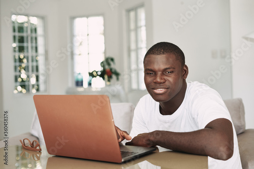 Male african american freelancer with laptop 