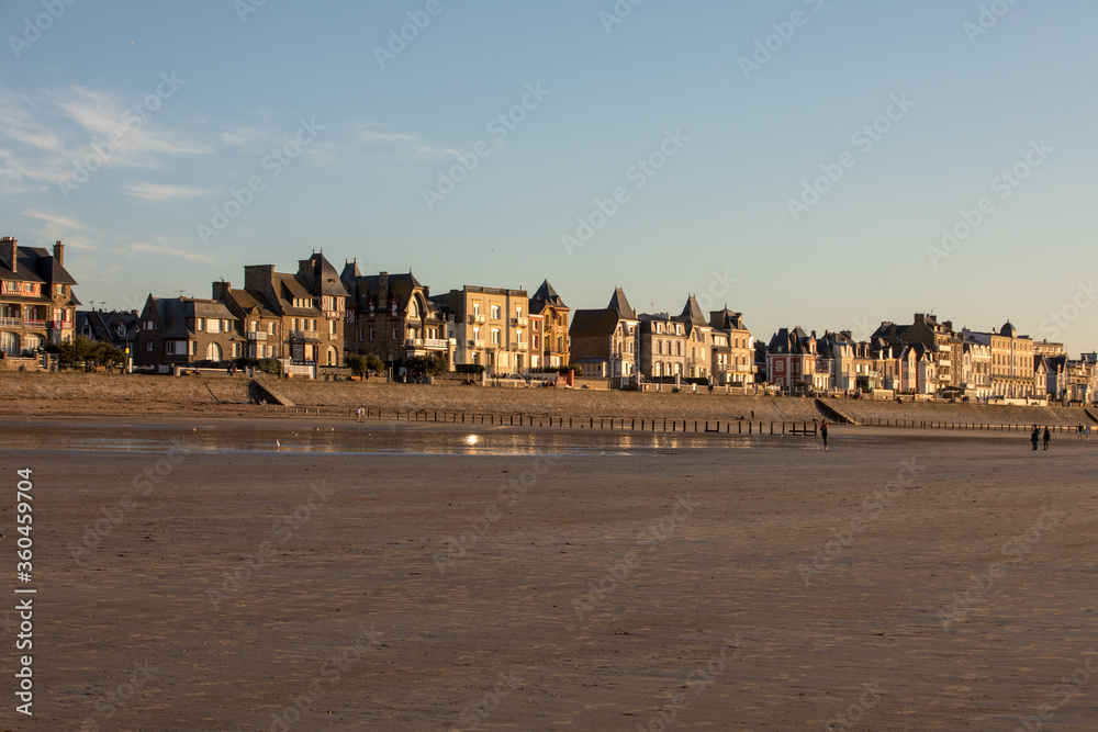 Beach in the evening sun and buildings along the seafront promenade in Saint Malo. Brittany, France