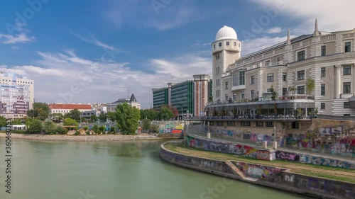 Urania and Danube Canal timelapse hyperlapse in Vienna at sunny summer day. Urania is a public educational institute and observatory photo