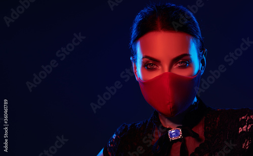 Stylish woman model wearing designer cloth face mask protect against coronavirus. Reusable fashionable face mask.