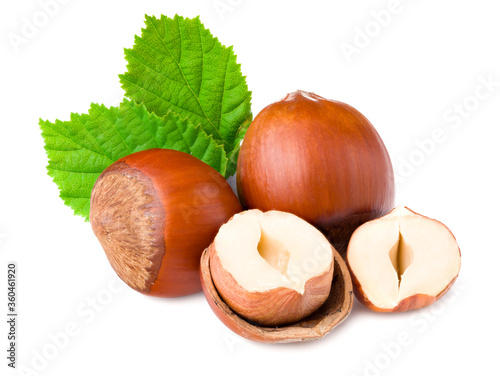 hazelnuts with green leaf isolated on white background