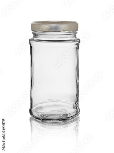 Empty glass jar with a lid. Isolated on a white background with reflection