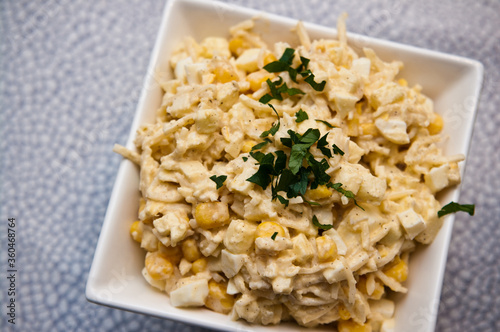 Bowl of vegetable salad of corn apples cellery and spices photo