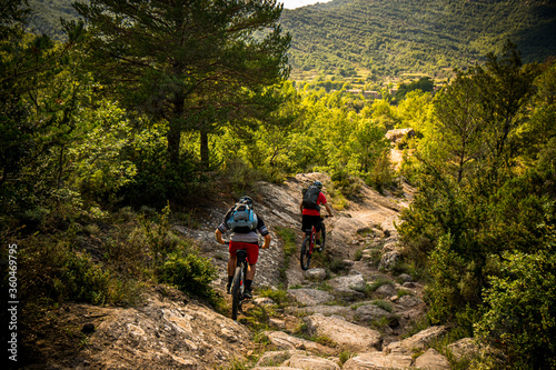 Two mountain bikers riding a dry river bend near Nocito in the Spanish Pyrenees