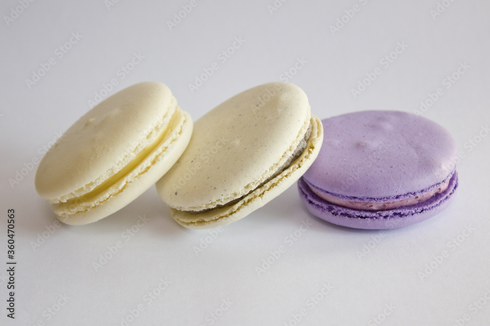 close up Sweet colorful macarons isolated on white background. close up Sweet colorful macarons isolated on white background.