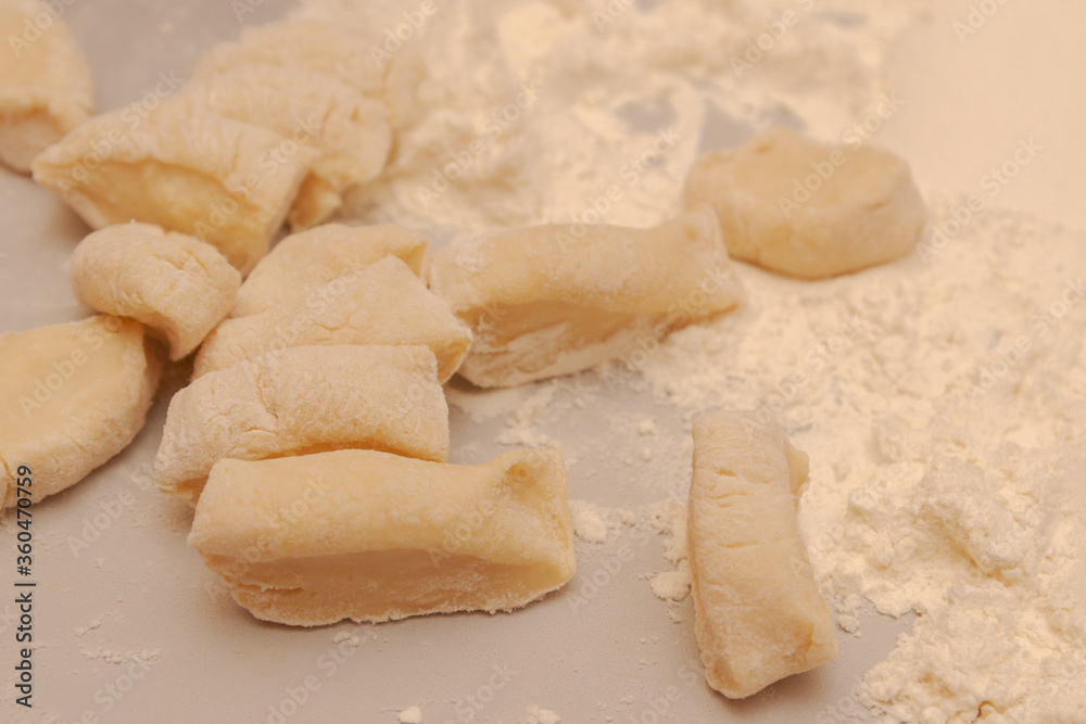 Sliced raw dough into pieces prepared for cooking homemade dumplings