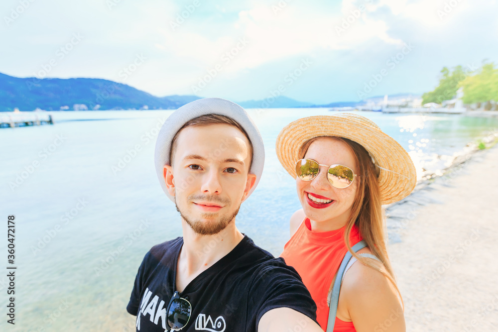 couple in love making tourist selfie. young girl with boater and