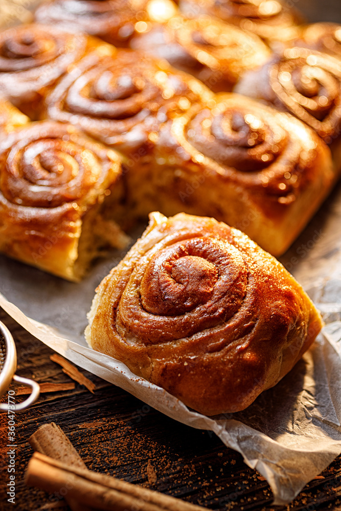 Homemade cinnamon buns on a wooden  rustic table, close up view