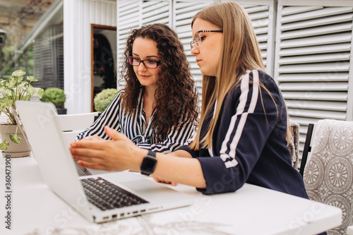 Corporate Communication.Two Businesswoman Working On Laptop In Modern Office. Free Space
