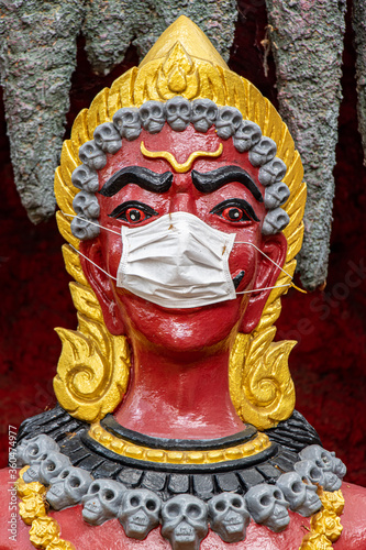 Obraz na plátně The portrait of the Demon King with face mask, Wat​ Muang​ temple​ located​ Ang​ Thong and Ayutthaya​ during coronavirus pandemic, Thailand