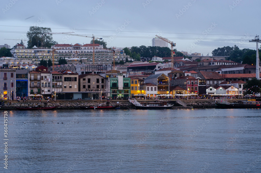 Obraz premium Douro river embankment at night, Ribeira district, Porto city on sunset, Portugal