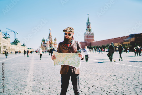 Photography Male tourist on Red Square exploring city map