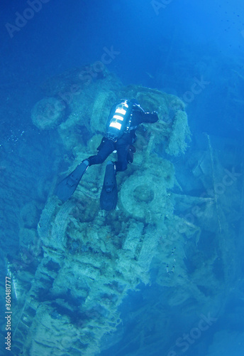 A scuba diver floats over the wreckage of a truck that was part of the cargo of the sunken ship wreck Zenobia  Cyprus