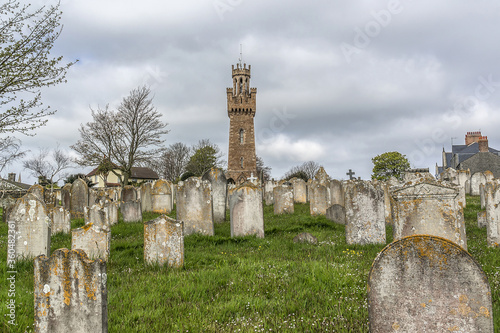 Victoria Tower and Candie Road Cemetery. Victoria Tower - famous monument in Saint Peter Port, Guernsey, erected in honor of visit by Queen Victoria and Prince Albert to Island in 1846.