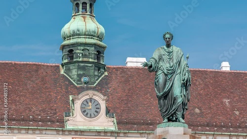 Statue of Kaiser Franz Joseph I timelapse at the Hofburg Palace in Vienna. It is located in the courtyard of Hofburg Palace. Blue sky at sunny day photo