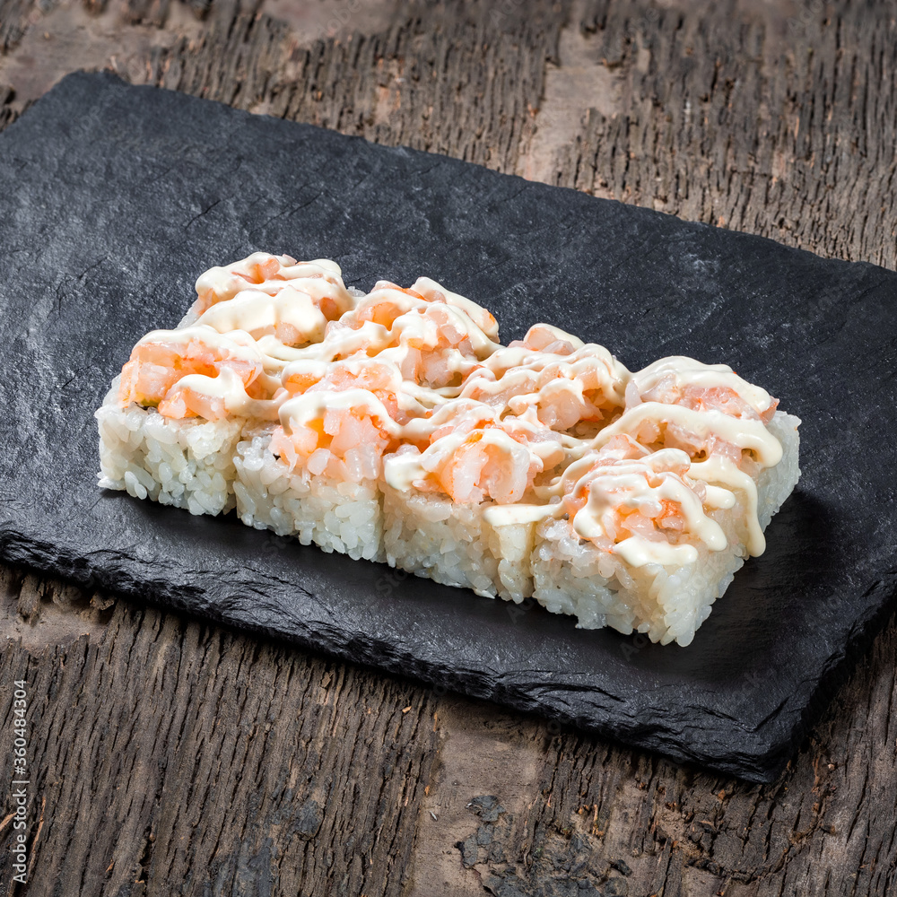 Japanese cuisine. Seafood, vegetables and meat. Sushi and rolls big set isolation on a wooden table background