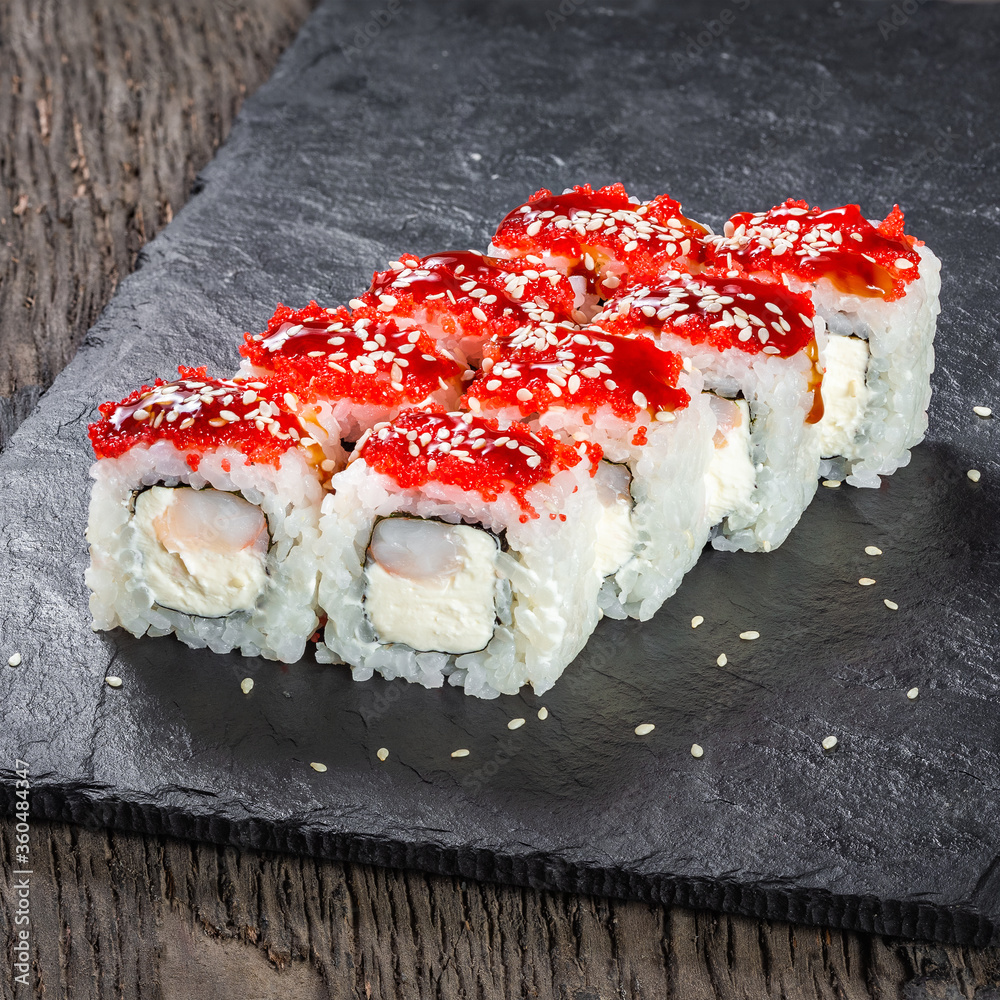 Japanese cuisine. Seafood, vegetables and meat. Sushi and rolls big set isolation on a wooden table background