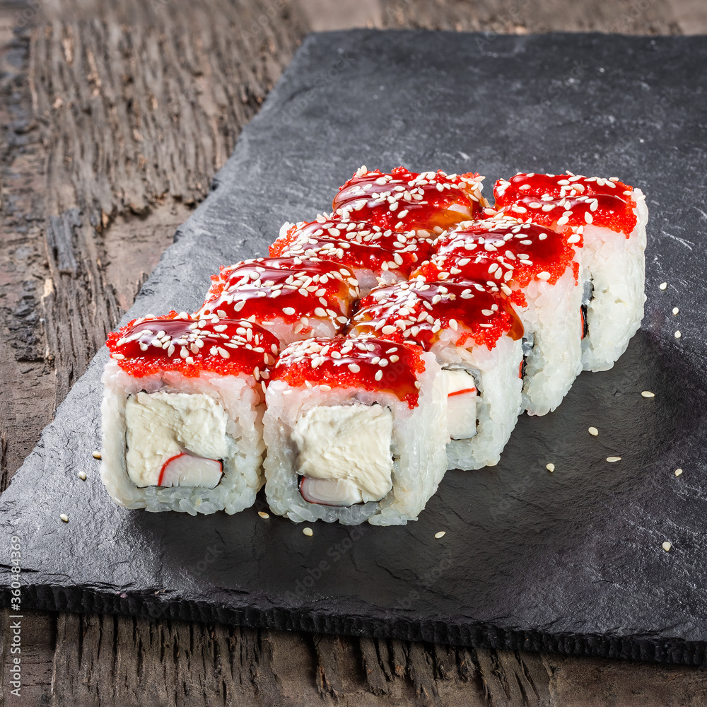 Japanese cuisine. Seafood, vegetables and meat. Sushi and rolls big set isolation on a wooden table background
