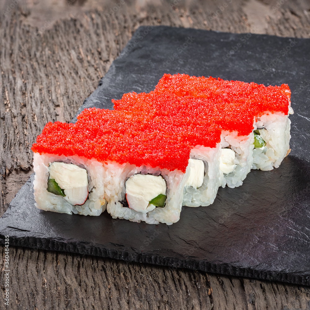 Japanese cuisine. Seafood, vegetables and meat. Sushi and rolls big set isolation on a wooden table background