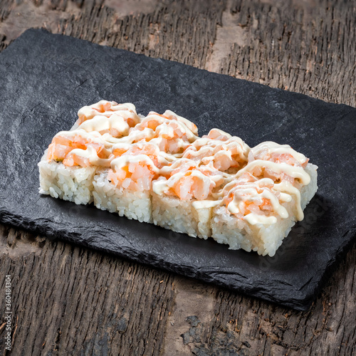 Obraz na płótnie Japanese cuisine. Seafood, vegetables and meat. Sushi and rolls big set isolation on a wooden table background w salonie