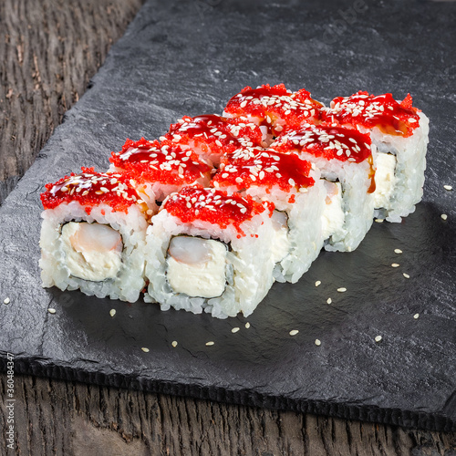 Obraz na płótnie Japanese cuisine. Seafood, vegetables and meat. Sushi and rolls big set isolation on a wooden table background w salonie