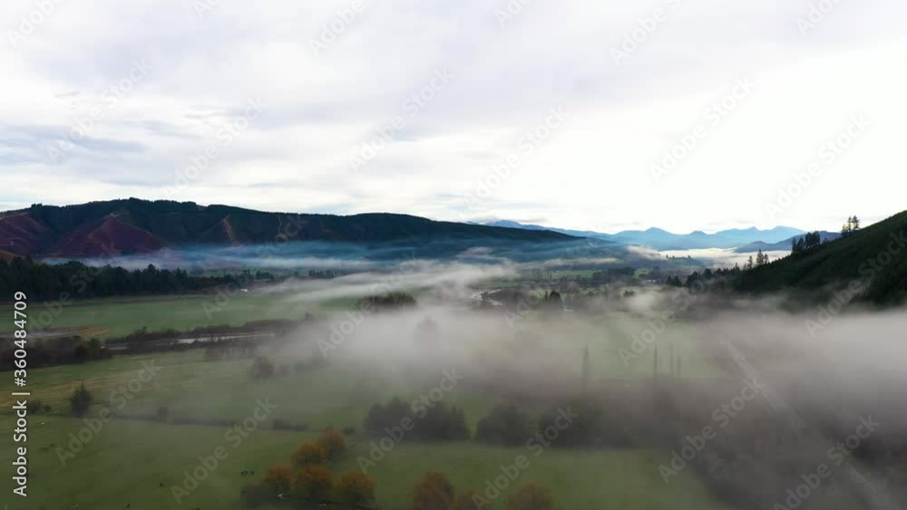 Low and slow aerial passover a misty valley Low and slow aerial passover a misty valley
