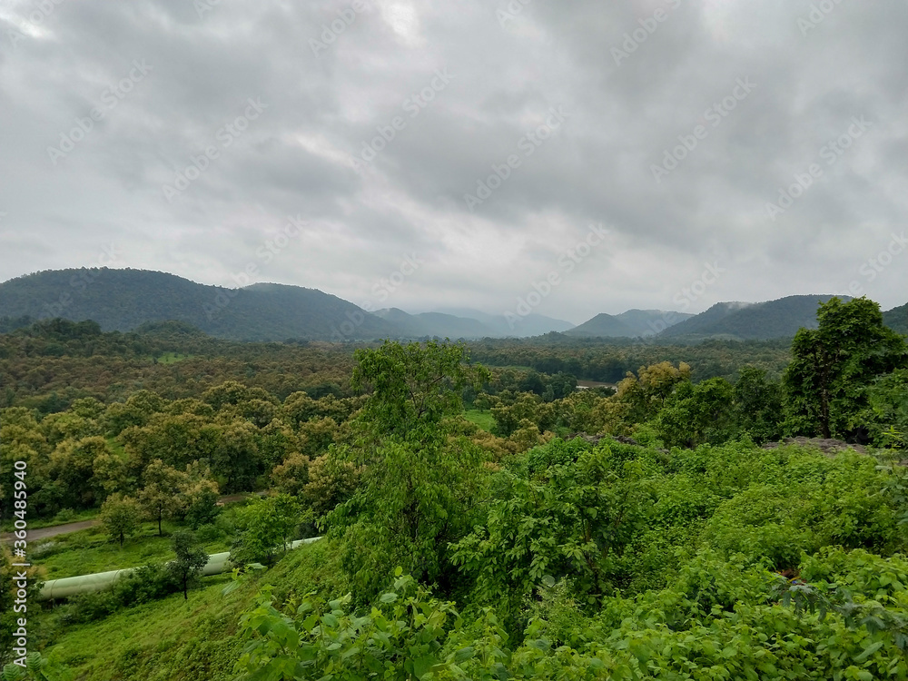 Tremendous green valley view with foggy mountains in the background in monsoon season at Central India