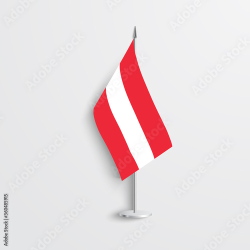 Austria table flag on light grey background. Austria desk flag on grey background.