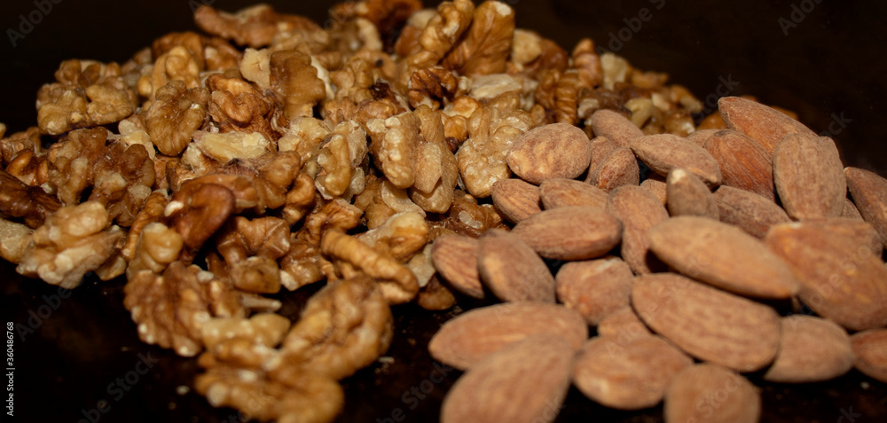 Closeup shot of a salted almonds and walnuts Closeup shot of a salted almonds and walnuts