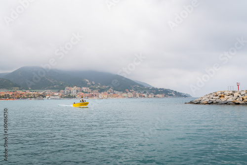 Yellow fishing boat sails in the harbor