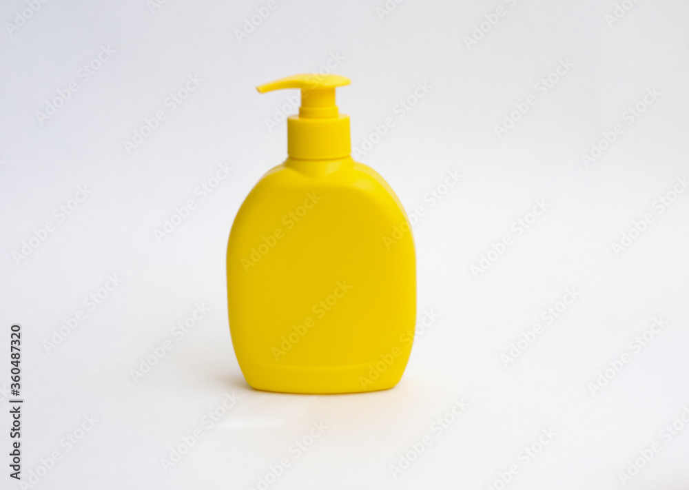 Shower gel, liquid soap plastic bottle of yellow color with a place for the text.