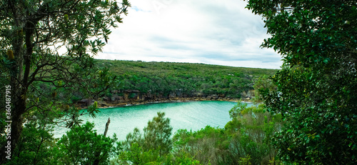 Panoramic views of Wattamolla Beach with waterfall tress turquoise blue waters and nice white sandy beach in sydney NSW Australia