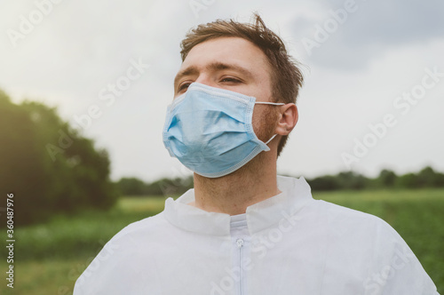 A man wearing a medical mask and breathing fresh air. Quarantine, world pandemic