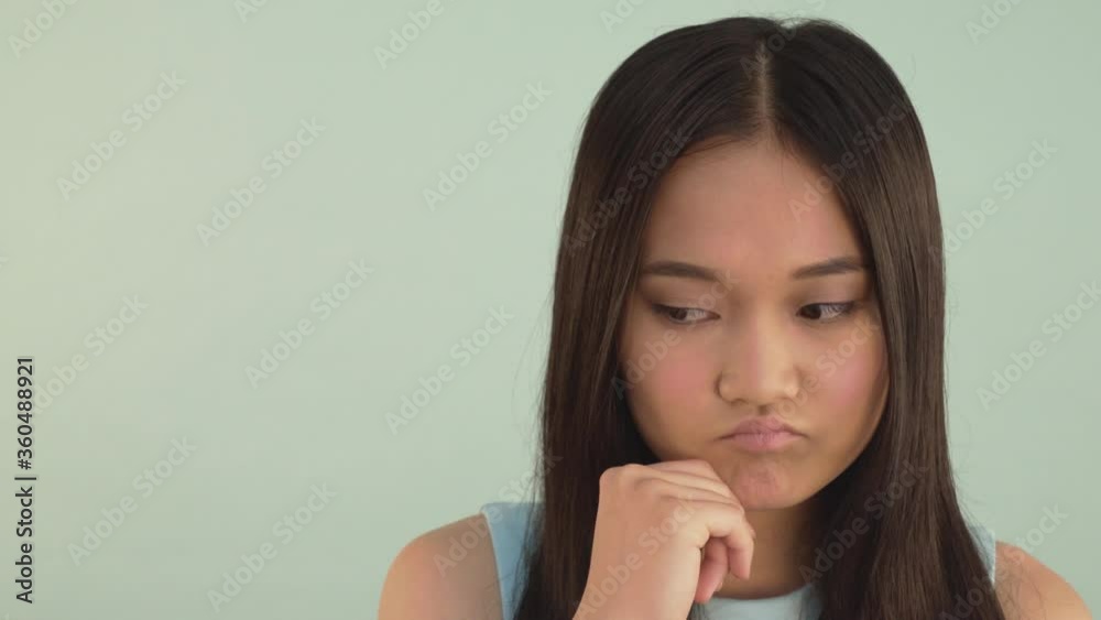 I have an idea! portrait close-up. Asian girl is concentrating on ideas. and finally finds a solution 4K I have an idea! portrait close-up. Asian girl is concentrating on ideas. and finally finds a solution 4K