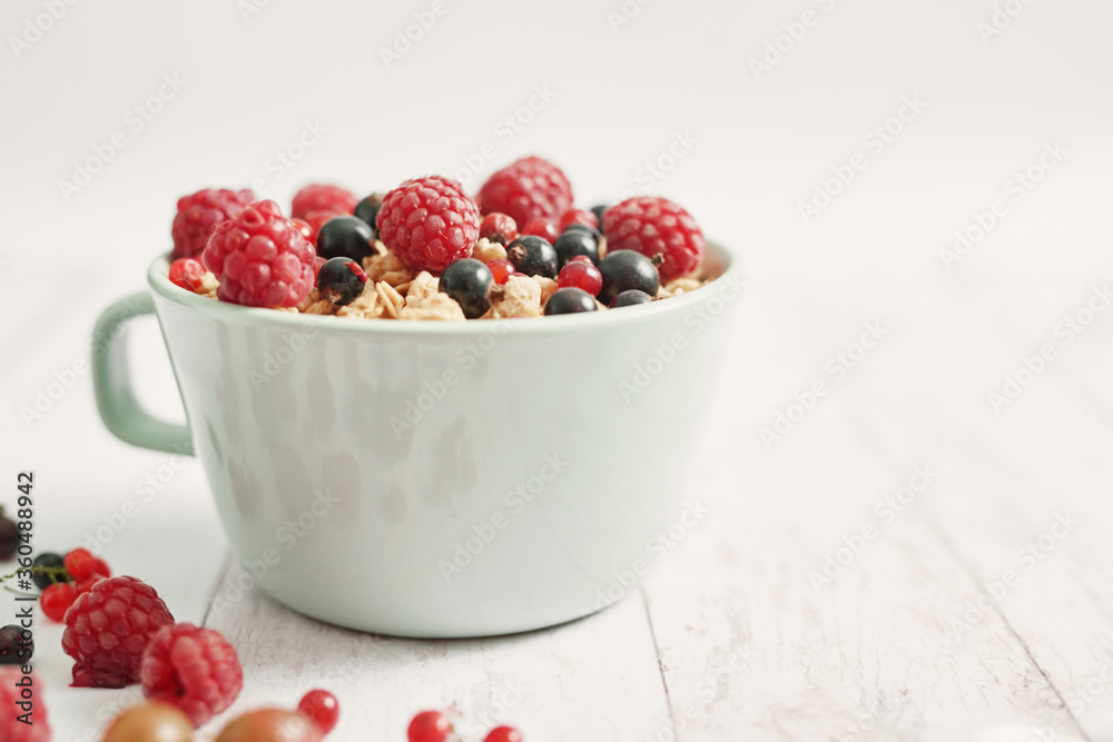 Colorful fresh berries on white background. Oatmeal with berries currants, raspberries, gooseberries. Vitamins, Diet. Copy space. Healthly food, detox. Cozy good morning! Summer Healthy breakfast Colorful fresh berries on white background. Oatmeal with berries currants, raspberries, gooseberries. Vitamins, Diet. Copy space. Healthly food, detox. Cozy good morning! Summer Healthy breakfast