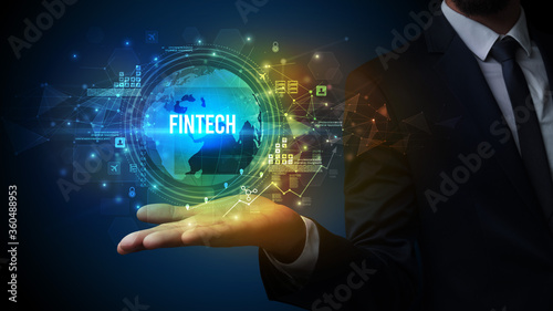 Elegant hand holding FINTECH inscription, digital technology concept