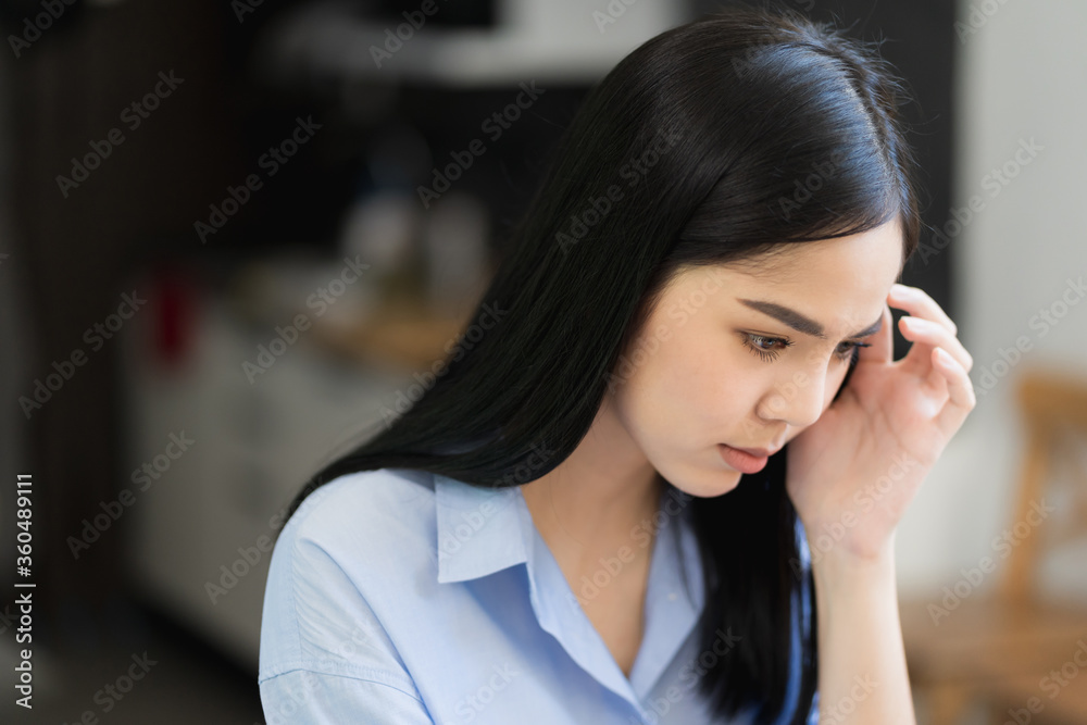 Depressed asian woman feeling suffer head in hands and headache. Depressed asian woman feeling suffer head in hands and headache.