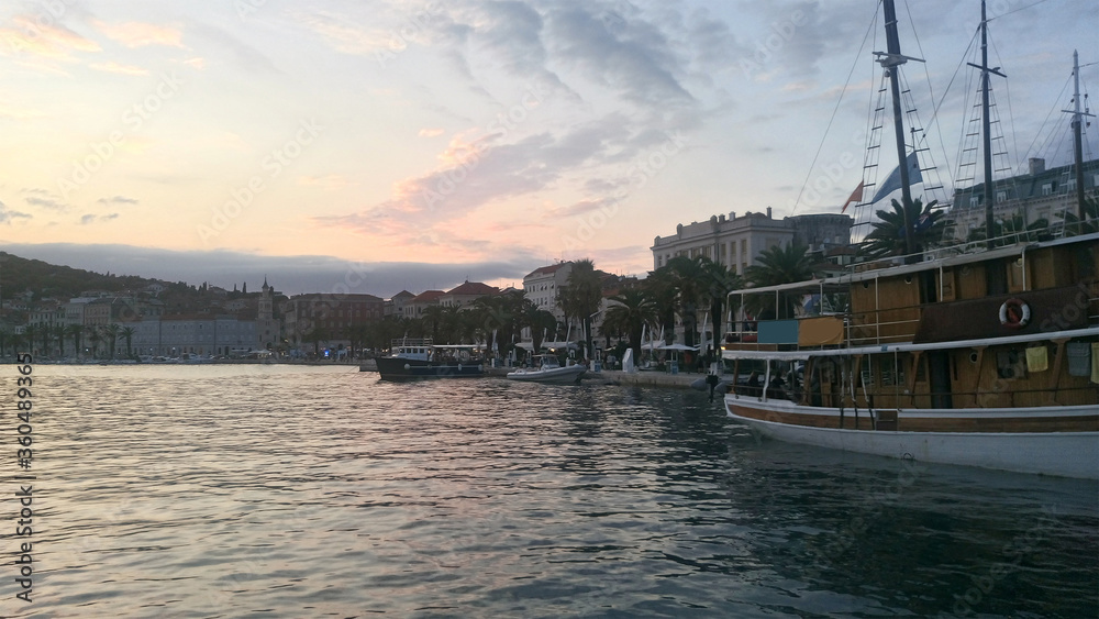 Beautiful sunset view over the port. Split seaport is located in the middle of Croatia, on the Adriatic coast, in a cozy bay, protected by breakwaters.