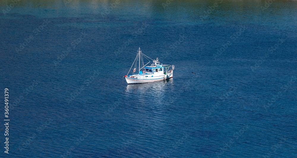 Kea, Tzia, Greece. Traditional fishing boat, trawler moored at Otzias cove.