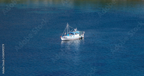 Kea, Tzia, Greece. Traditional fishing boat, trawler moored at Otzias cove.
