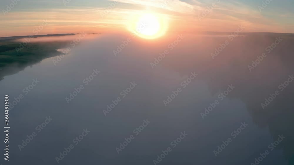 Aerial view of the summer fog forming over the lake during sunrise Aerial view of the summer fog forming over the lake during sunrise