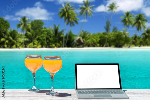 orange juice laptop on the beach