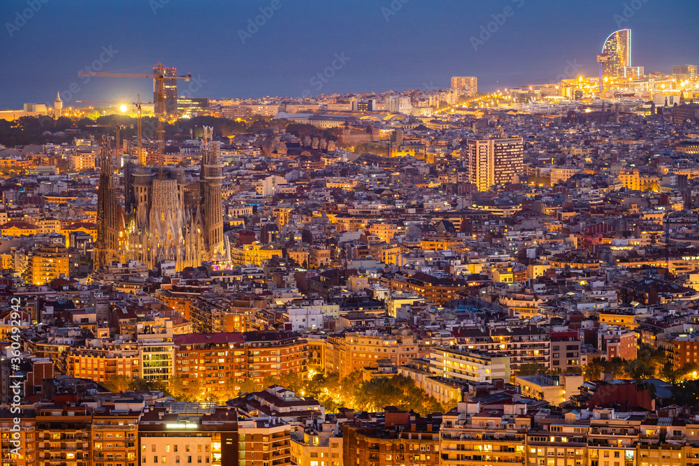 Aerial view of Barcelona cityscape at dusk in Catalonia, Spain.