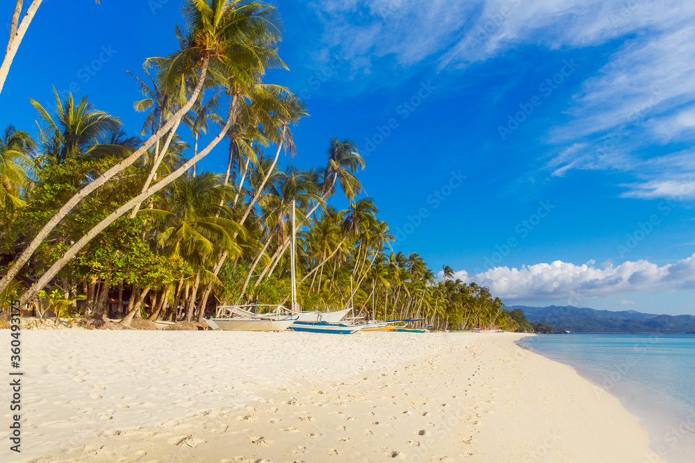 Beautiful sunset on the tropical beach on Boracay island, Philippines. Coconut palm trees, sea, sailboat and white sand. Nature view. Summer vacation concept. Beautiful sunset on the tropical beach on Boracay island, Philippines. Coconut palm trees, sea, sailboat and white sand. Nature view. Summer vacation concept.