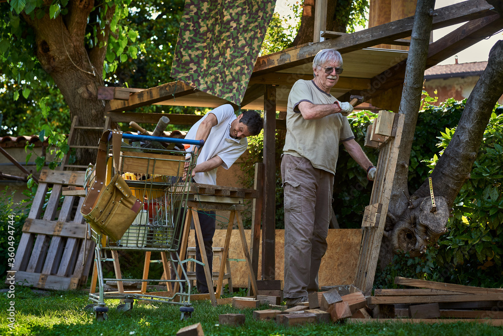 Active senior men working on the backyard Active senior men working on the backyard