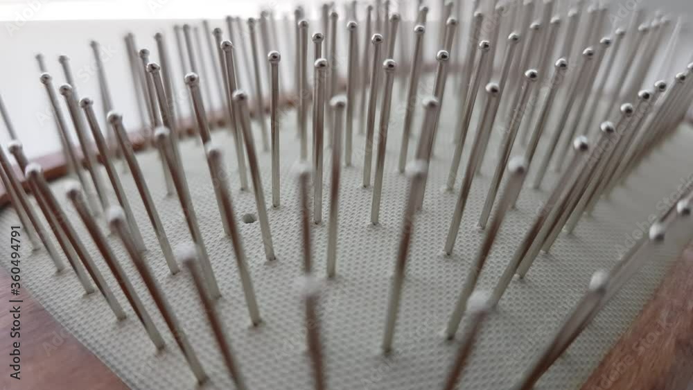Wooden massage hair brush with iron bristles, macro side view. Wooden massage hair brush with iron bristles, macro side view.