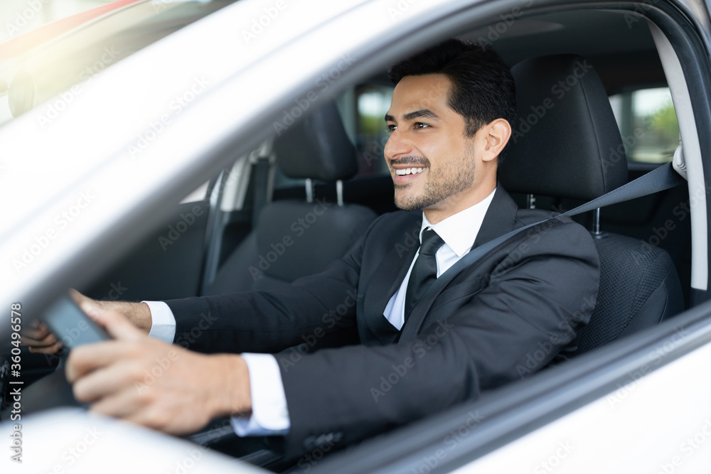 Smiling Male Business Executive Driving Car