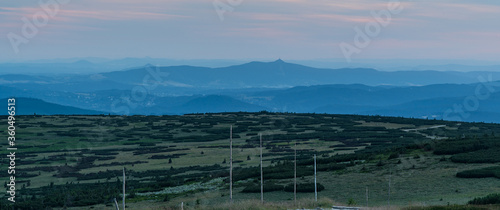 Jested hill with few other mountain ranges around from Vysoka Plan hill above Sniezne Kotly in Krkonose mountains after sunset